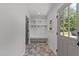 Bright mudroom with built-in shelving, coat hooks, a bench, and a view of the outdoors at 7204 Laketree Dr, Raleigh, NC 27615