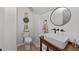 Stylish powder room with wood vanity, vessel sink, and modern fixtures at 7204 Laketree Dr, Raleigh, NC 27615