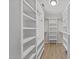 Spacious walk-in closet featuring custom shelving and ample storage space at 7204 Laketree Dr, Raleigh, NC 27615