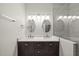 Bathroom features dual sinks, modern lighting, glass-enclosed shower, and contemporary fixtures at 7340 Doverton Ct, Raleigh, NC 27615