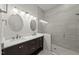 Bright bathroom with dual sinks, modern lighting, and a glass-enclosed shower at 7340 Doverton Ct, Raleigh, NC 27615