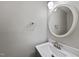 Modern bathroom features a white vanity, sink, round mirror, and silver fixtures at 7340 Doverton Ct, Raleigh, NC 27615