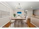 Elegant dining room with modern chandelier, six chairs, and views to the stairs at 7340 Doverton Ct, Raleigh, NC 27615