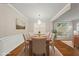 Elegant dining room featuring modern lighting, decorative trim and an inviting color palette at 7340 Doverton Ct, Raleigh, NC 27615