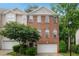 Charming brick townhome featuring a two-car garage and beautifully landscaped front yard at 7340 Doverton Ct, Raleigh, NC 27615