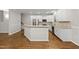 Bright kitchen with stainless steel appliances, granite countertops, and hardwood floors at 7340 Doverton Ct, Raleigh, NC 27615