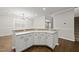 Bright eat-in kitchen features white cabinets, stainless steel hardware, and dark hardwood flooring at 7340 Doverton Ct, Raleigh, NC 27615