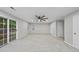 Spacious living room with a ceiling fan, sliding door to patio, multiple windows and neutral carpet at 7340 Doverton Ct, Raleigh, NC 27615