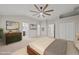 Staged main bedroom features carpet floors, a ceiling fan, ensuite bathroom, and walk-in closet at 7340 Doverton Ct, Raleigh, NC 27615