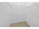 Bright walk-in closet featuring carpeted floors and multiple levels of wire shelving for optimal storage at 7340 Doverton Ct, Raleigh, NC 27615