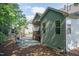 Well-maintained backyard features a deck and patio, surrounded by lush greenery at 7660 Channery Way, Raleigh, NC 27616