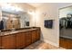 Bathroom featuring double sinks, wood cabinets, tile floors and a walk-in closet at 7660 Channery Way, Raleigh, NC 27616
