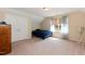Bright bedroom features a large window, carpeted floors, and ample closet space for storage at 7660 Channery Way, Raleigh, NC 27616