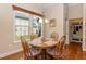 Cozy breakfast nook with wood table, four chairs and natural light coming in from windows at 7660 Channery Way, Raleigh, NC 27616