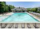 A large community pool is surrounded by lounge chairs, offering a refreshing escape and social gathering place at 7660 Channery Way, Raleigh, NC 27616