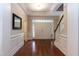 Grand foyer with gleaming hardwood floors, a staircase, and a view of the front doors at 7660 Channery Way, Raleigh, NC 27616