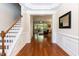 Open foyer with hardwood floors that leads to the spacious living room and staircase at 7660 Channery Way, Raleigh, NC 27616