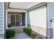 Inviting front entrance with double doors, stone accents, and well maintained landscaping at 7660 Channery Way, Raleigh, NC 27616