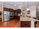 Modern kitchen with stainless steel appliances, granite countertops, and custom cabinetry at 7660 Channery Way, Raleigh, NC 27616