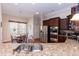 Well-equipped kitchen featuring stainless steel appliances and stone countertops at 7660 Channery Way, Raleigh, NC 27616