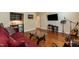 Cozy living room features a wet bar, TV and music area, perfect for relaxing and entertaining at 7660 Channery Way, Raleigh, NC 27616