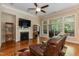 Cozy living room with fireplace, hardwood floors, a ceiling fan, and natural light at 7660 Channery Way, Raleigh, NC 27616