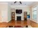 Inviting living room with a fireplace, hardwood floors, and access to other rooms at 7660 Channery Way, Raleigh, NC 27616