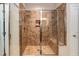 Walk-in shower featuring a glass door, tiled walls, and built-in seat at 7660 Channery Way, Raleigh, NC 27616