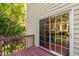 Wooden deck with view of wooded backyard and sliding glass door at 7761 Winners Edge St, Raleigh, NC 27617