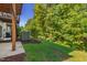 Backyard with grass, trees, and an air conditioning unit at 7761 Winners Edge St, Raleigh, NC 27617