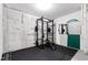 Basement gym featuring rubber flooring and a squat rack with weights at 7761 Winners Edge St, Raleigh, NC 27617