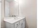 Bathroom vanity featuring white cabinetry, hardware, sink, and mirror at 7761 Winners Edge St, Raleigh, NC 27617