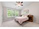 Bedroom with three windows overlooking trees and a bed with side tables at 7761 Winners Edge St, Raleigh, NC 27617