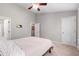 Bedroom with light walls, ceiling fan, carpeting, and ensuite doors at 7761 Winners Edge St, Raleigh, NC 27617