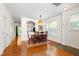 Dining area with hardwood floors, classic furniture, and bright natural light from the large window at 7761 Winners Edge St, Raleigh, NC 27617