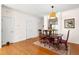 Bright dining room with hardwood floors and classic wooden table set for a cozy meal at 7761 Winners Edge St, Raleigh, NC 27617