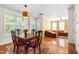 Bright dining room with hardwood floors, classic furniture, and open access to the living area at 7761 Winners Edge St, Raleigh, NC 27617