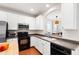 Well-lit kitchen with stainless steel appliances and dark countertops at 7761 Winners Edge St, Raleigh, NC 27617