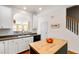 Open kitchen with a butcher block island and arched pass-through at 7761 Winners Edge St, Raleigh, NC 27617