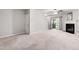 Carpeted living room featuring a fireplace, storage closet, and sliding door to the outdoors at 7761 Winners Edge St, Raleigh, NC 27617