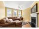 Comfortable living room featuring a plush sectional sofa, fireplace, and bright natural light at 7761 Winners Edge St, Raleigh, NC 27617
