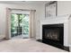 Bright living room featuring a fireplace, sliding door, and access to the outdoors at 7761 Winners Edge St, Raleigh, NC 27617