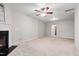 Spacious living room features a fireplace, ceiling fan and neutral carpet at 7761 Winners Edge St, Raleigh, NC 27617