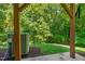 Covered patio with view of wooded backyard and air conditioning unit at 7761 Winners Edge St, Raleigh, NC 27617