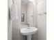 Elegant powder room featuring a pedestal sink, modern faucet, and stylish mirror at 7761 Winners Edge St, Raleigh, NC 27617