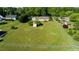Expansive fenced backyard featuring a storage shed, mature trees, and a lush, well-maintained lawn at 78 Cross Creek Ct, Timberlake, NC 27583