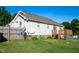 Fenced backyard featuring a wooden deck, grassy lawn, and mature trees at 78 Cross Creek Ct, Timberlake, NC 27583