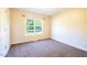 Well-lit bedroom with neutral walls, carpet, and a window offering views of the surrounding landscape at 78 Cross Creek Ct, Timberlake, NC 27583