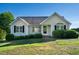 Inviting single-story home featuring manicured bushes, a welcoming entrance and light-colored siding at 78 Cross Creek Ct, Timberlake, NC 27583