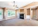 Bright living room with a fireplace, built-in shelves, and a ceiling fan at 78 Cross Creek Ct, Timberlake, NC 27583